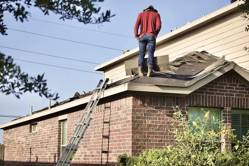 Professional roofer working on a residential roof in Hancock Park